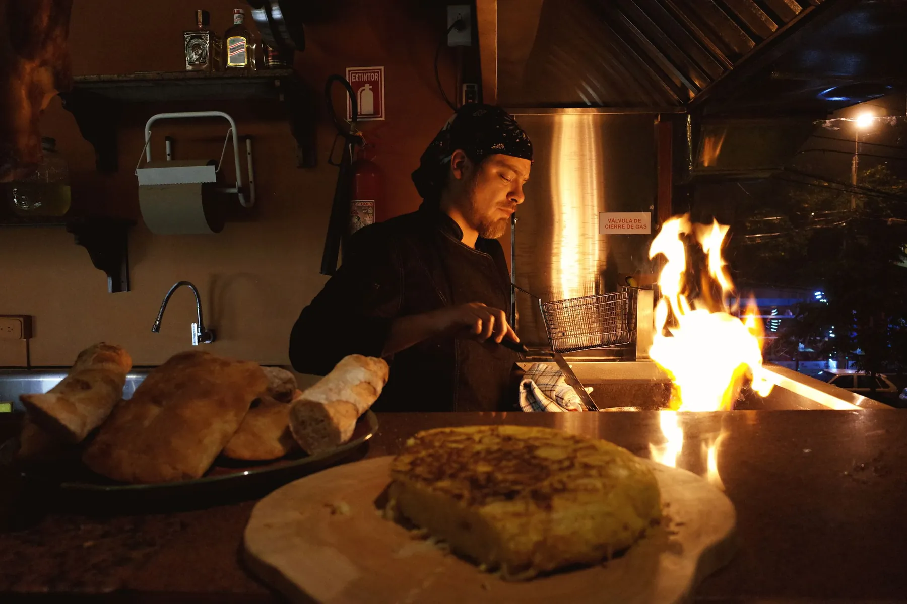 A cook working at the open hearth